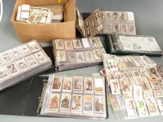 Four cigarette card albums including military motors, British birds, Churchman's Association