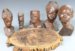 Five tribal/African wooden heads and a leather tribal cushion