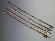 Four stick violin bows, one with possibly ivory frog with ebony throat and nose, Parisian eye, two