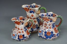 Three Masons graduated octagonal jugs with snake handles, tallest 23cm