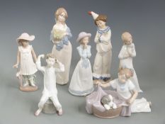 Seven Nao, Nadal and similar child figures, tallest 24cm