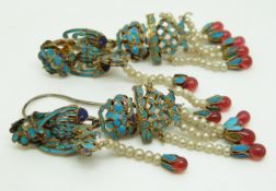 A pair of Chinese silver gilt earrings in the form of a bird and floral decoration set with