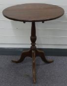 19thC oak tilt top table raised on a tripod base, diameter 63cm