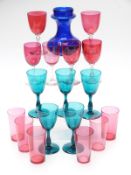 Seventeen cranberry and green drinking glasses together with a Bristol Blue glass vase, 14.5cm tall