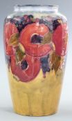Moorcroft vase decorated in the Pomegranate pattern with eight pomegranates including four open,