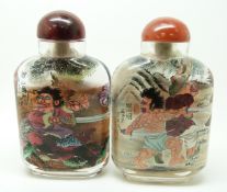 Two Japanese reverse painted glass scent bottles depicting Samurai warriors, with agate stoppers,