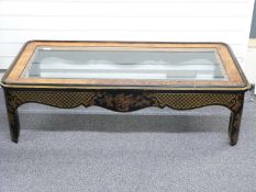A hardwood and beveled glass topped coffee table with chinoiserie decoration, W143 x D77 x H41cm