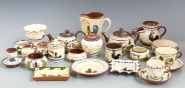 A collection of Torquay / Devon Motto Ware including two teapots, waisted jug, shaving mug, tea ware