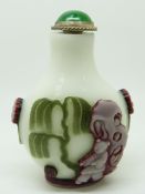 Chinese glass overlay scent bottle with decoration depicting a figure and insects, 6.5cm tall