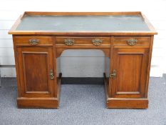 A leather inset twin pedestal mahogany desk with wooden gallery, W123 x D54 x H76cm