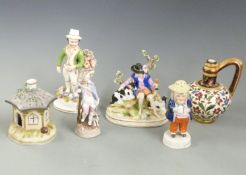A collection of three continental figures, Staffordshire Jolly Toby pepper, a Staffordshire pastille