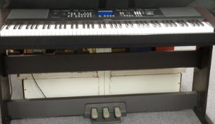 Yamaha DGX-650 portable grand piano keyboard with pedals, stand and carry bag