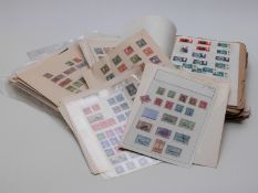 A large quantity of mint and used GB stamps and foreign stamps on loose album sheets