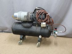 A large electric compressor with hose raised on four wheels, script to side 2kw, 11 bar
