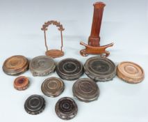 A collection of Chinese hardwood stands including some with carved/pierced decoration, largest 24cm