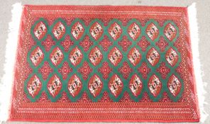 Turkoman rug with 24 guls on a green ground, 196 x 127cm