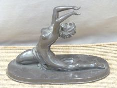 A figurine of a semi-nude female dancer