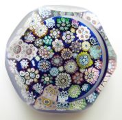 Peter McDougal millefiori paperweight on blue ground with cut facets, 5.5cm diameter