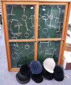 A mounted collection of horse bits in glazed pine cabinet with sliding doors together with seven