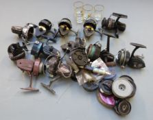Large quantity of vintage fishing reels including Intrepid, Shakespeare and Mitchell, spools and