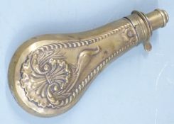 G & J W Hawksley brass powder flask with embossed decoration to both sides, 19cm long.