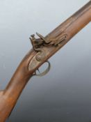 Unnamed flintlock hammer action gun with engraved lock stamped 'Warranted', brass trigger guard