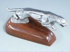 Jaguar car mascot on wooden display base, length 20cm