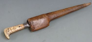 Eastern, possibly Afghan tribal Pesh-kabs with steel blade, decorated handle and leather sheath,