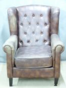 A contemporary faux leather Chesterfield wing back armchair, H98cm