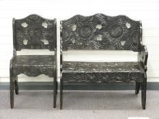 A wooden bench seat and chair with profusely carved flower decoration c1920s/30s, the bench W91