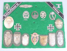 German Third Reich Nazi replica war badges and battle shields together with two Iron Crosses mounted