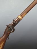 Kentucky style flintlock hammer action rifle with ornate brass storage compartment to the lock,