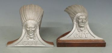 Two Guy car or lorry mascots formed as native Indians, both on wooden display stands, width of wider