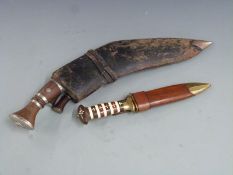 Two kukris and a sheath knife in wooden scabbard