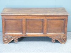 An 18th/19thC three panel oak coffer raised on carved scrolling feet, W126 D50 H60cm