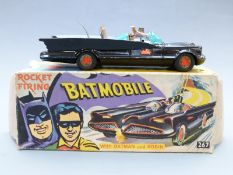 Corgi Toys diecast model Batmobile 1st type with no tow hook, black body, figures and bat logo hubs,