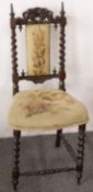 Small upholstered hall chair with ornately carved back.
