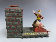 Novelty cast iron mechical 'Artillery Bank' money bank with a cannon firing a coin into a tower,