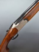 The Silver Snipe 12 bore over and under ejector shotgun with engraved scenes of birds to the lock