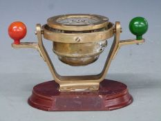 Small ship's nautical compass with Nelson's balls, on wooden base, width 23cm