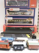 Twenty-four Hornby, Lima, BaCHmann and similar 00 gauge model railway locomotives, coaches and