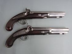 A pair of percussion hammer action pistols with engraved locks, hammers, trigger guards and top