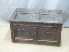 A 17th/18thC carved oak two panel trunk with interior nine division cellarette style compartment,