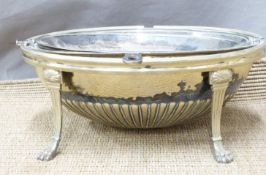 A plated food warmer with revolving lid, raised on lion pad feet