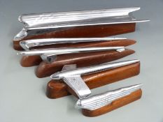 Five various likely American car mascots or hood ornaments including a winged example, head with