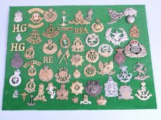 A collection of cap badges and shoulder titles including Bristol University OTC, 1st Battalion