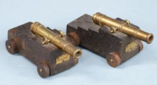 A pair of miniature brass signalling or table cannon with plaques marked 'Victory' and multi-stage