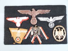 Six German Third Reich Nazi badges mounted on card