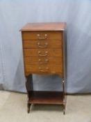 A mahogany music or filing chest of five drawers with undershelf, drawers with hinged drop action