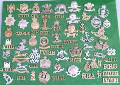 Over 60 British Army cap badges and shoulder titles for cavalry regiments including Royal